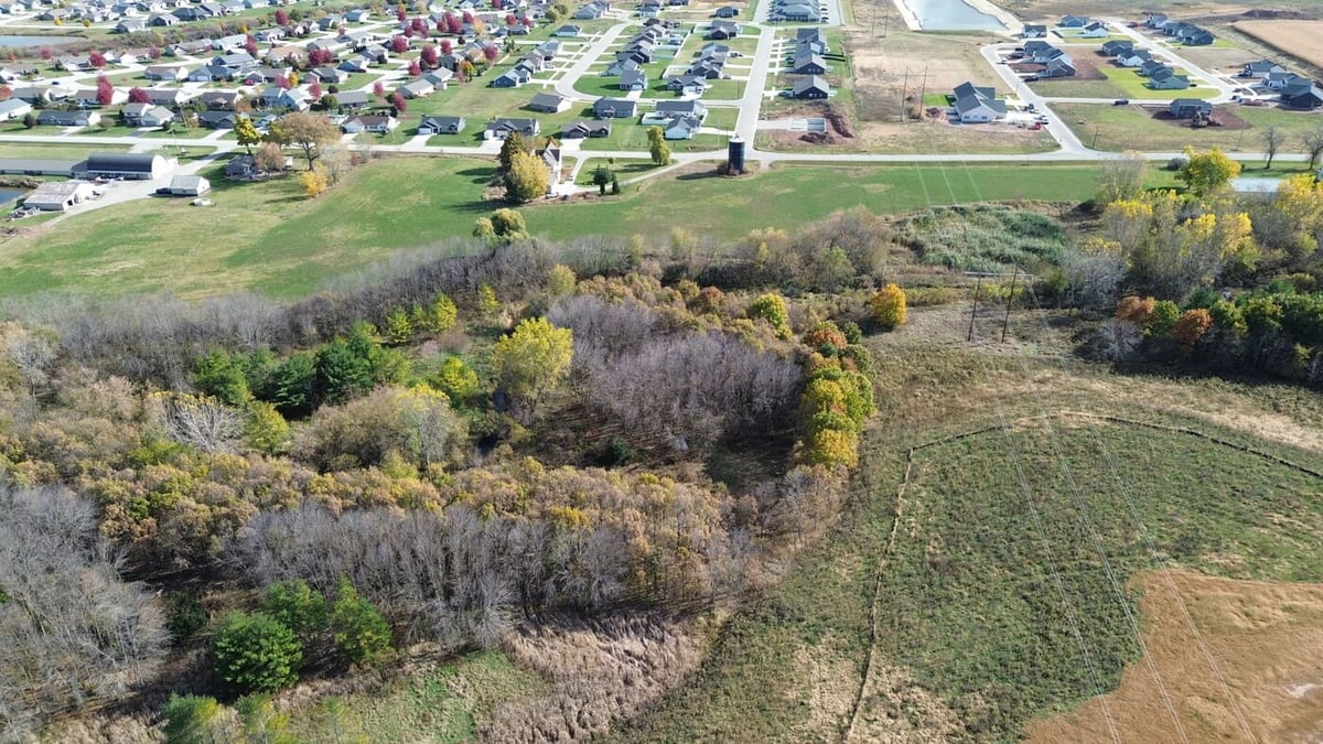 Aerial view of wooded land for sale in De Pere, WI bordering established neighborhood homes