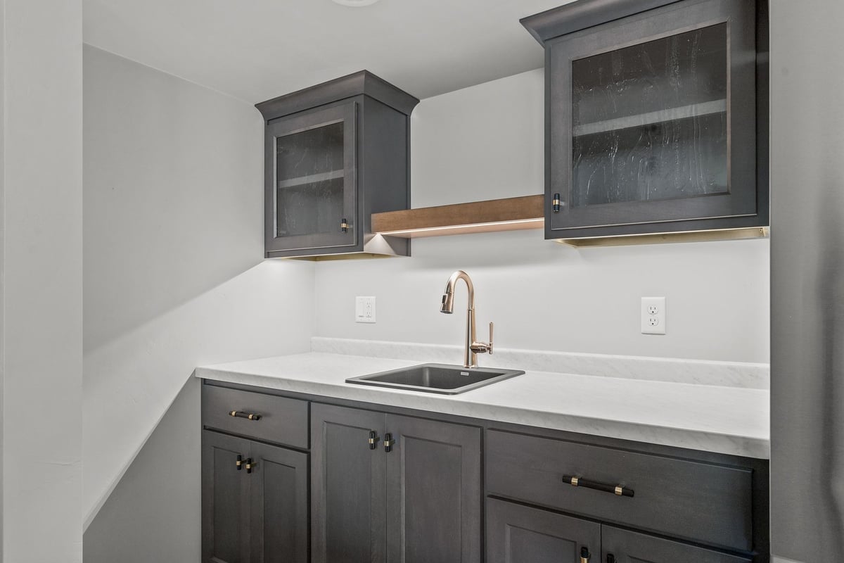 Basement bar sink and upper cabinets in Wisconsin custom home by Midwest Design Homes