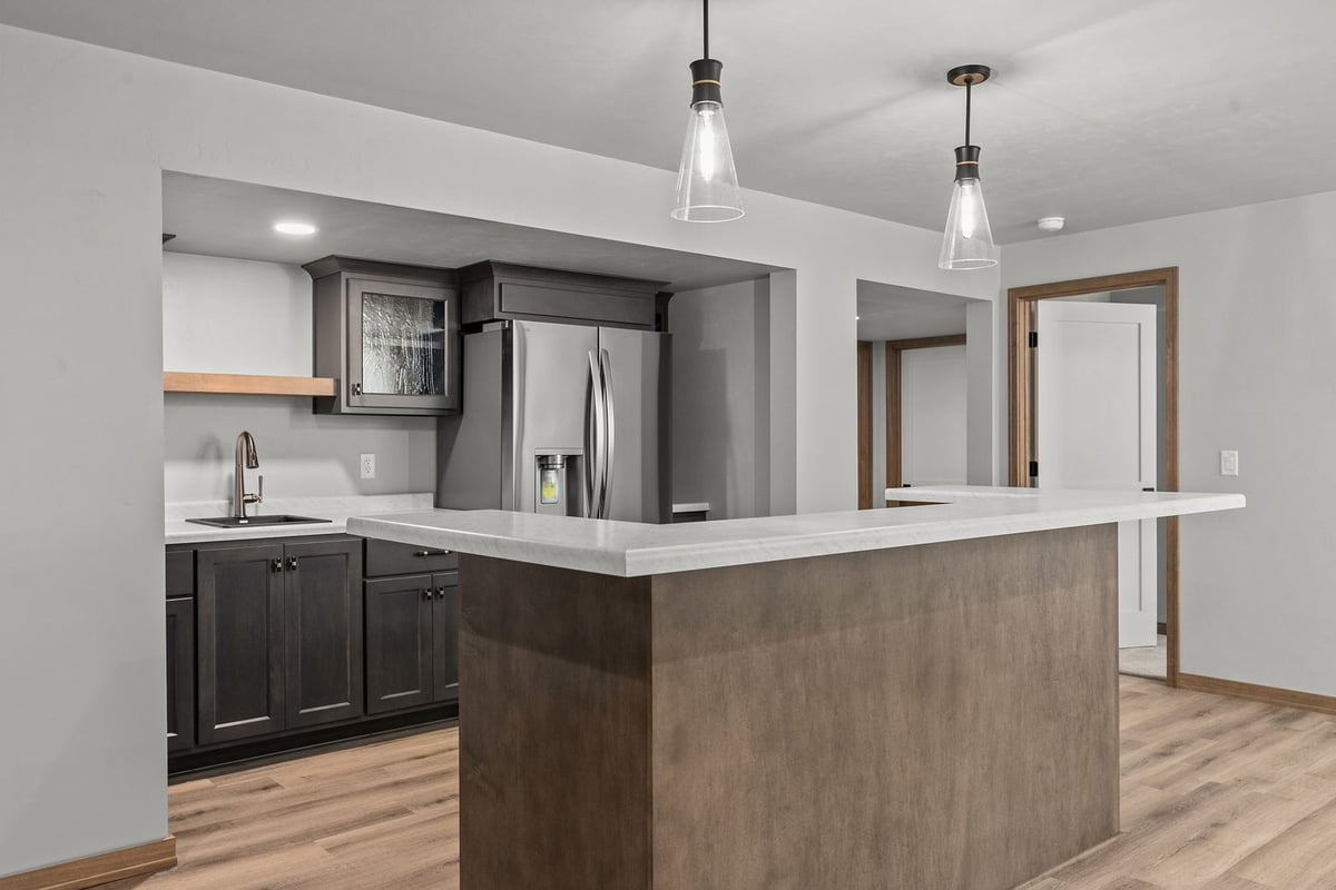 Basement wet bar with pendant lights in custom home by Midwest Design Homes, WI