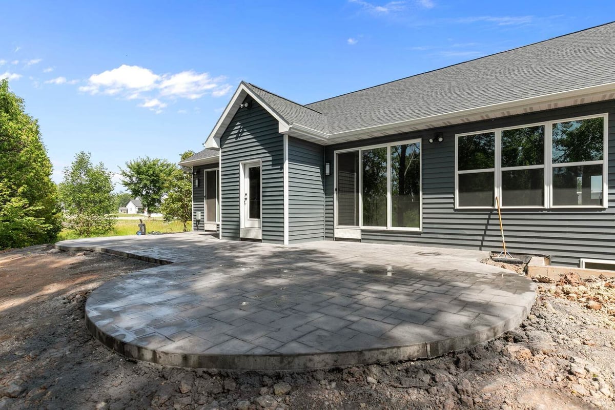 Curved stamped patio at rear of Wisconsin custom home by Midwest Design Homes