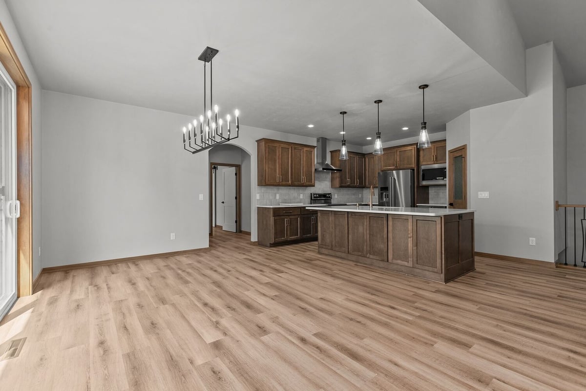 Dining room with chandelier in Ellington home by Midwest Design Homes, WI