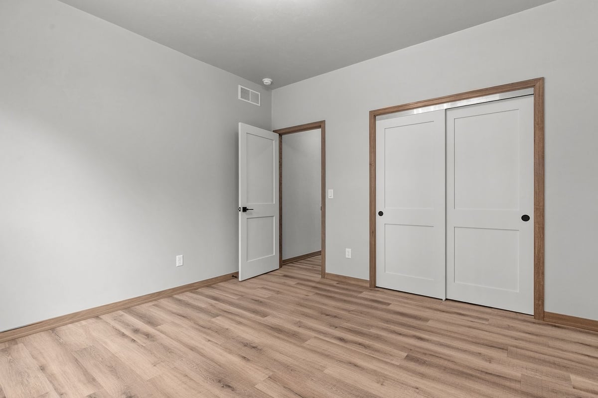 Double closet bedroom with white doors by Midwest Design Homes in Bellevue, Wisconsin