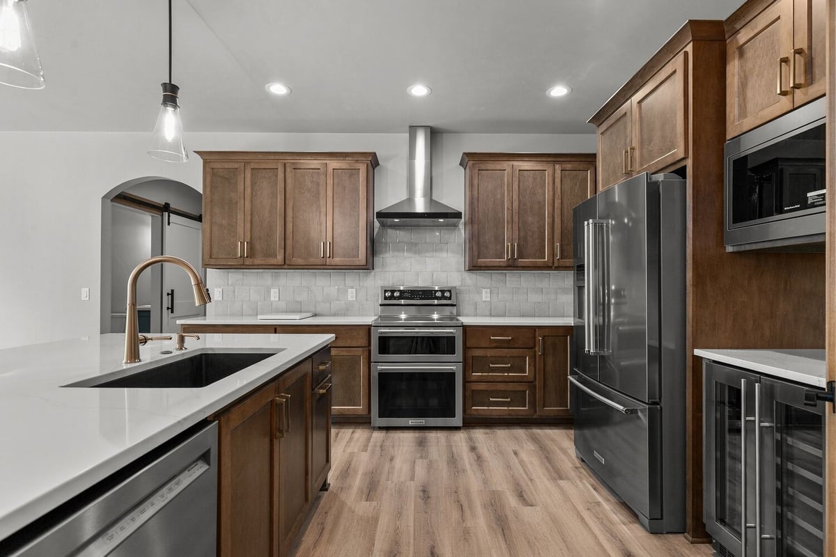 Fox Cities custom kitchen by Midwest Design Homes with modern appliances and vent hood