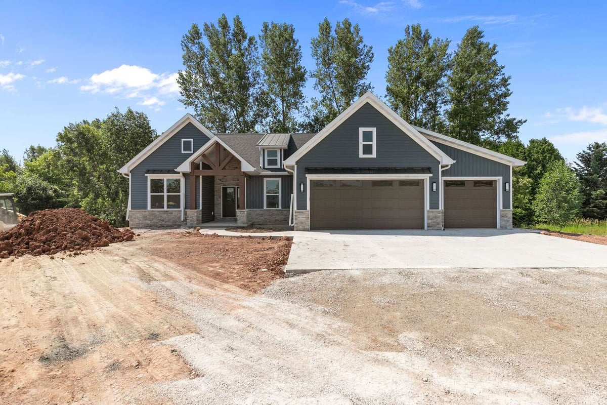 Front view of Wisconsin custom home with three-car garage by Midwest Design Homes