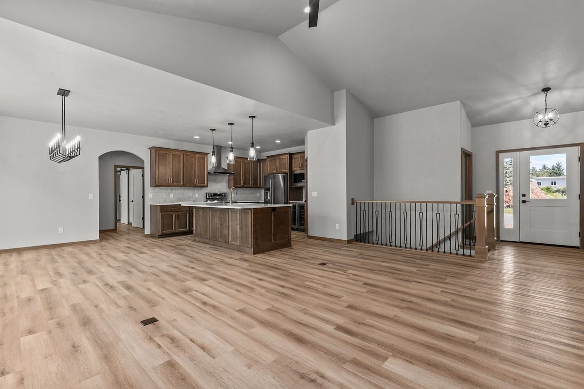 Lawrence home entry and kitchen with pendant lights by Midwest Design Homes