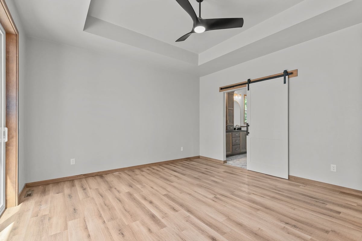 Master bedroom with sliding door to bath by Midwest Design Homes in Fox Cities, WI