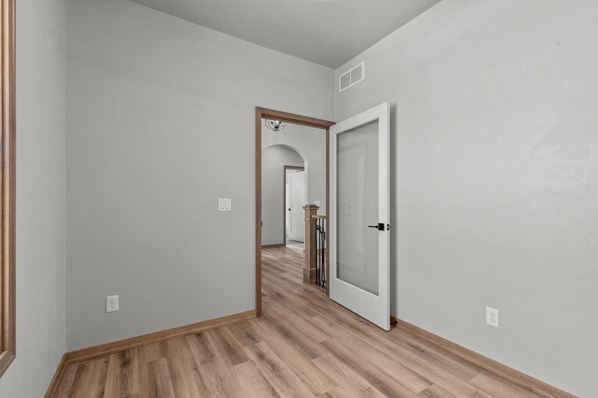 Office with glass door and wood trim by Midwest Design Homes in Green Bay, WI