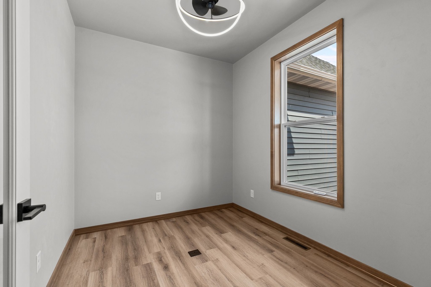 Small office with modern ceiling light by Midwest Design Homes in Fox Cities, WI
