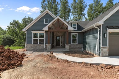 Stone and blue siding exterior entry in WI custom home by Midwest Design Homes