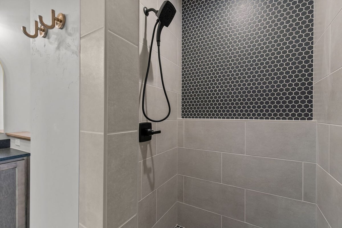Tiled shower with hex accent wall by Midwest Design Homes in Kaukauna, Wisconsin