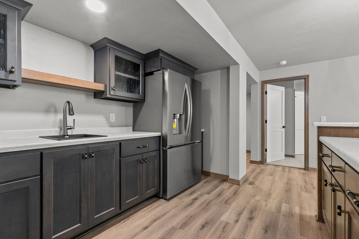 Wet bar with modern cabinetry in custom WI basement by Midwest Design Homes