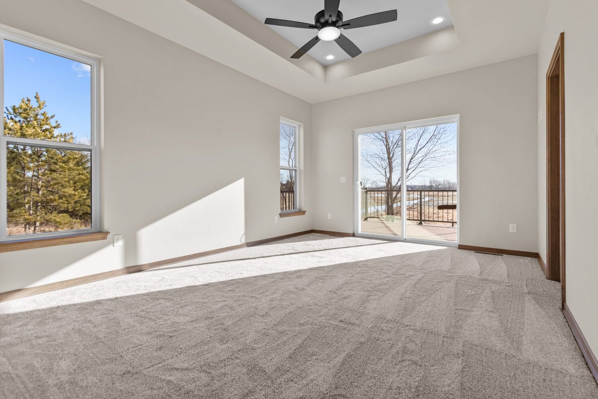 Bright master bedroom with tray ceiling by Midwest Design Homes in Kaukauna, WI
