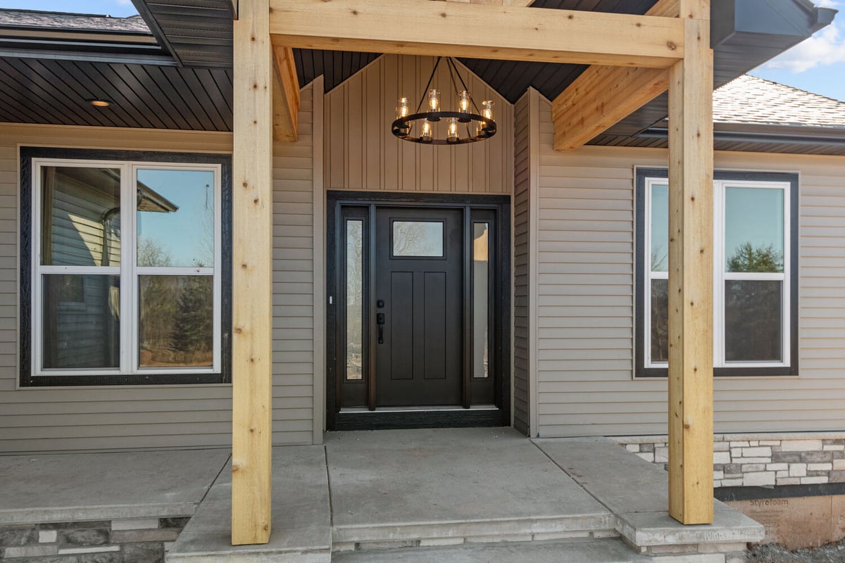 Close-up of covered entry and front door on Wisconsin home by Midwest Design Homes
