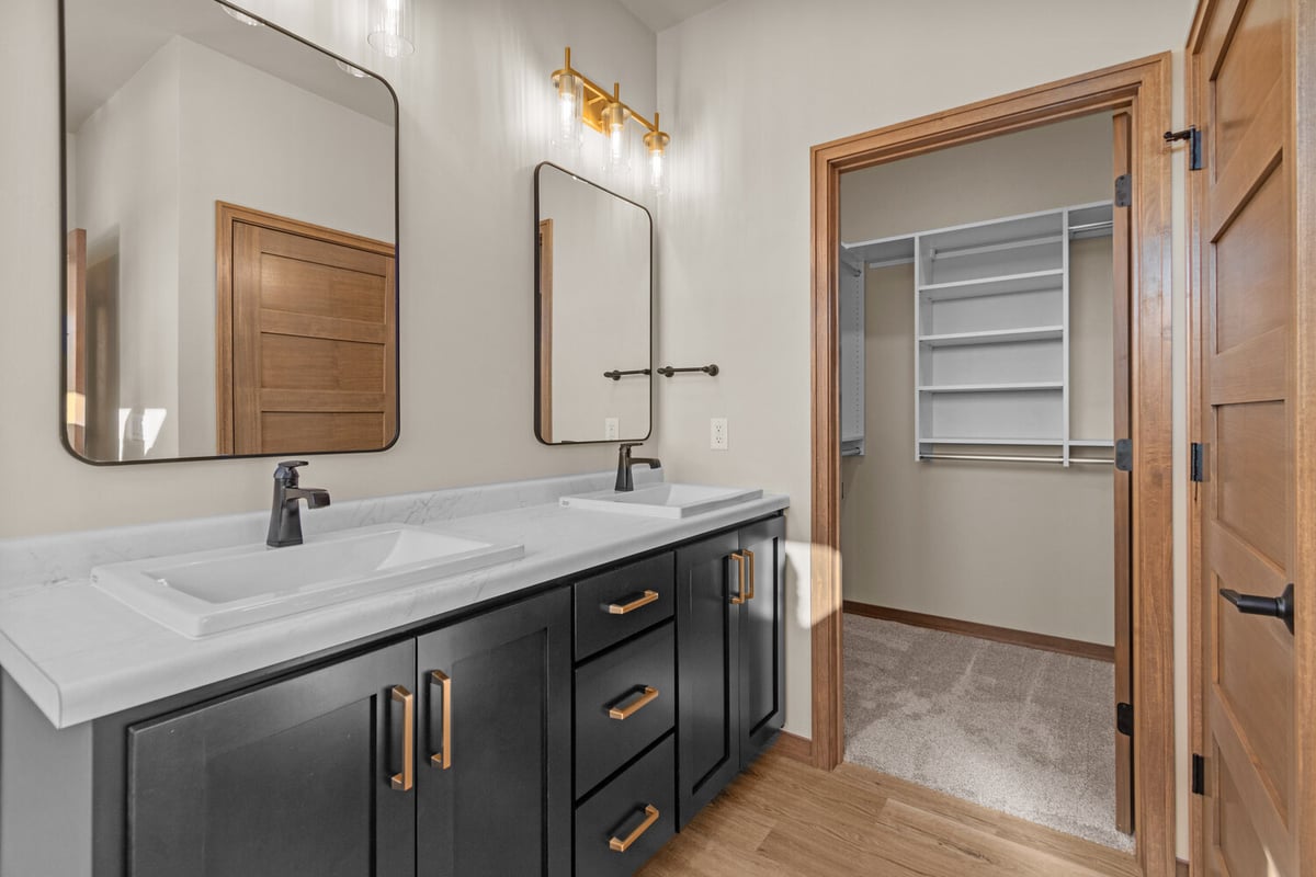 Custom dual sink vanity with mirrors in Kaukauna home by Midwest Design Homes