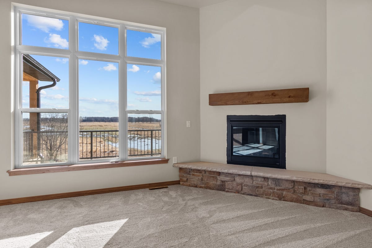 Fireplace corner and large windows in Wisconsin custom home by Midwest Design Homes