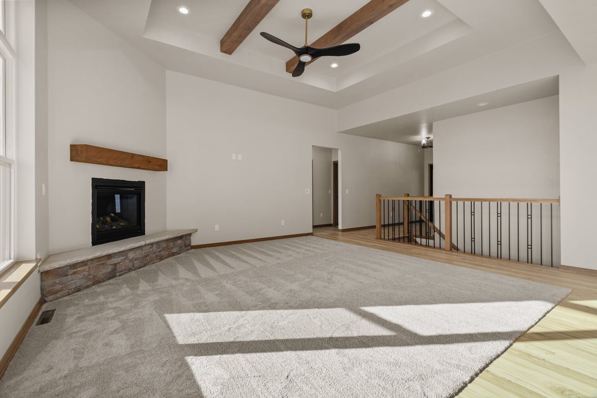 Living room with stone fireplace in custom home near Harrison, WI by Midwest Design Homes