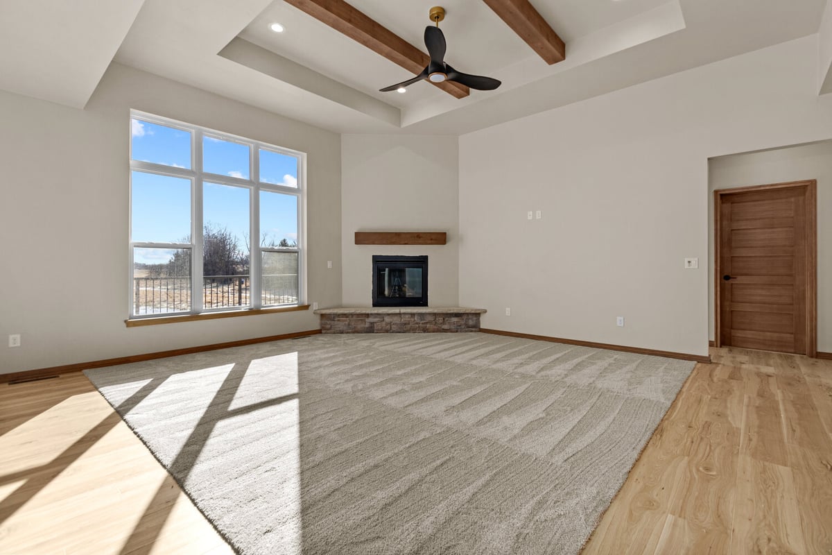 Natural light in living room with fireplace in Kaukauna, WI custom home by Midwest Design Homes