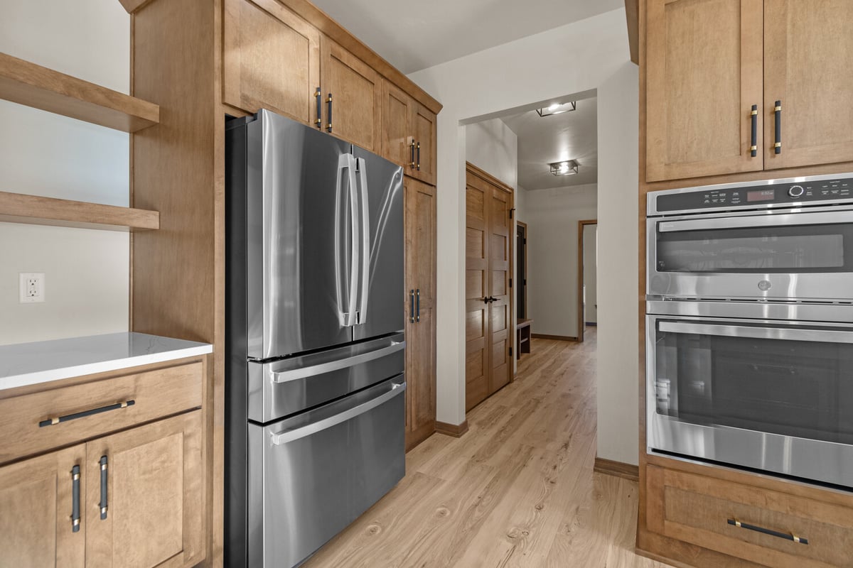 Stainless fridge and double ovens in Harrison, WI custom kitchen by Midwest Design Homes