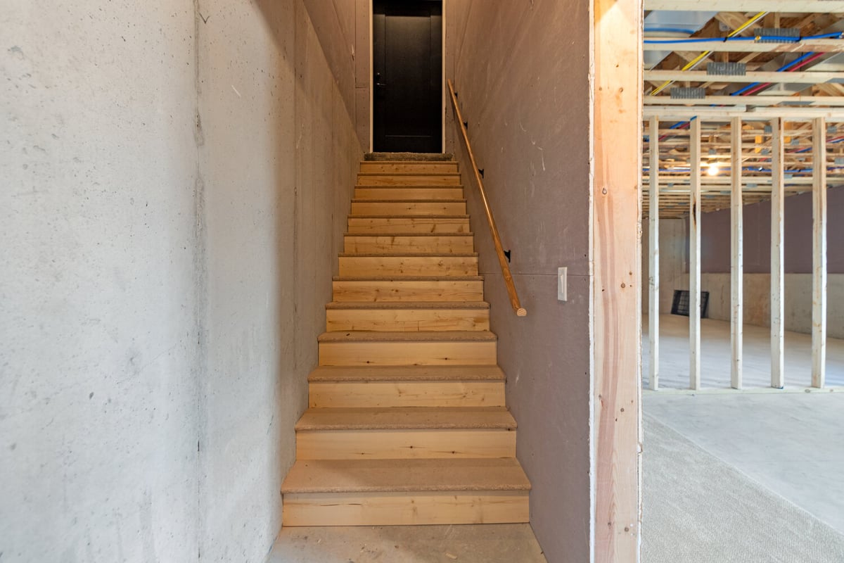 Stairwell access to unfinished basement in custom home in Ellington, WI