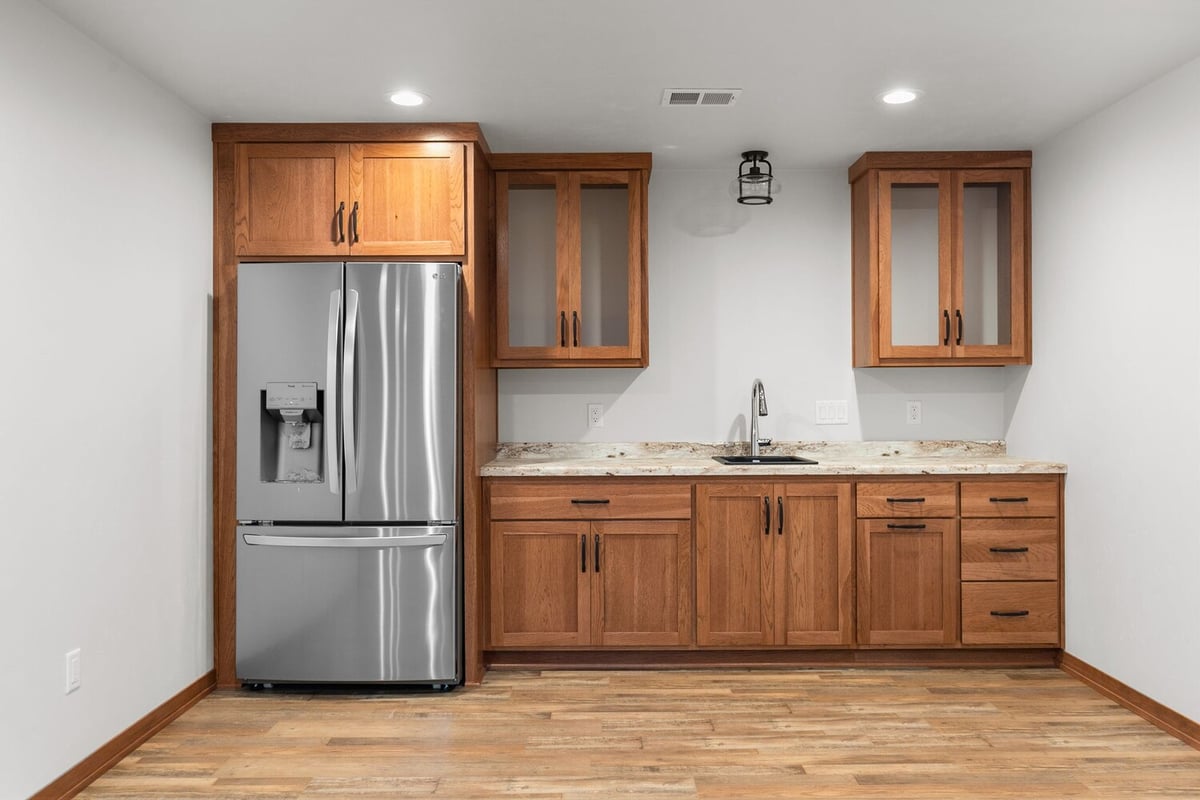 Basement kitchenette with stainless fridge by Midwest Design Homes, Kaukauna, WI