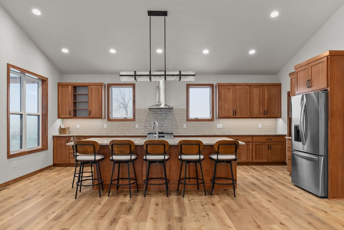 Full kitchen view with six-seat island in Kaukauna by Midwest Design Homes, Wisconsin