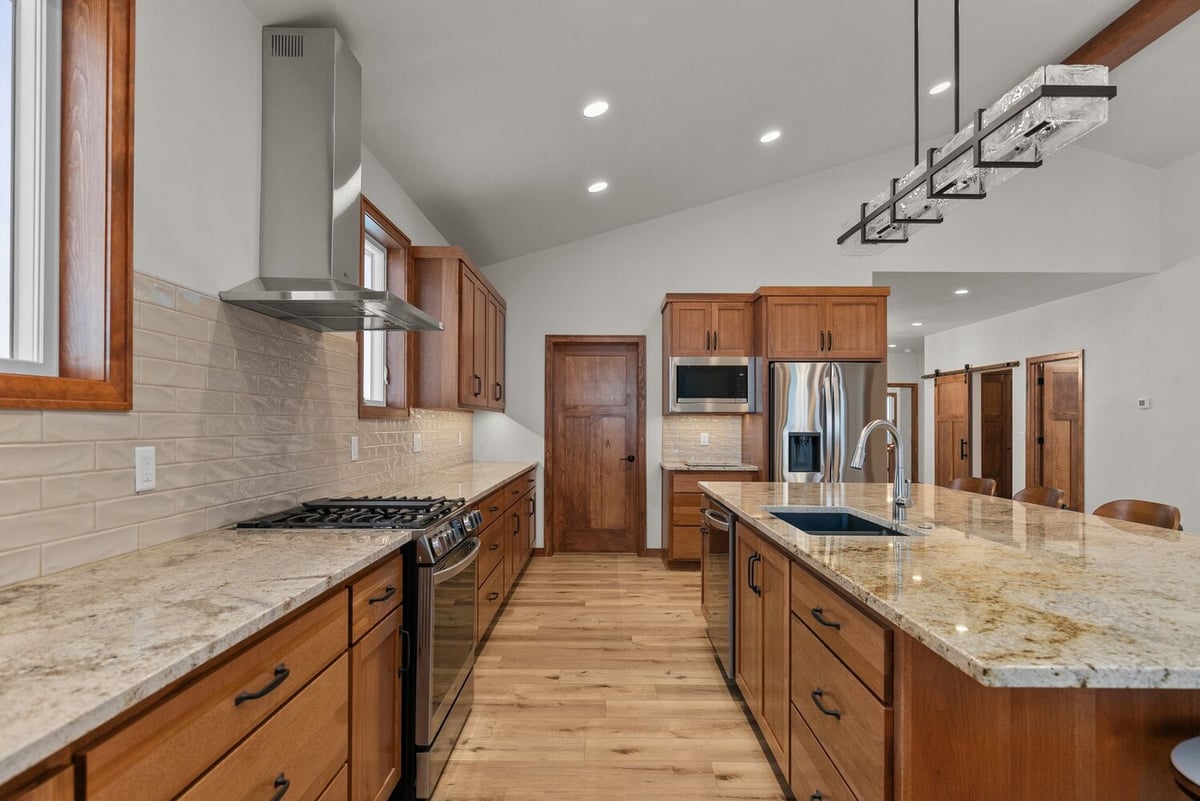 Granite countertops and wood cabinets in Wisconsin custom home by Midwest Design Homes