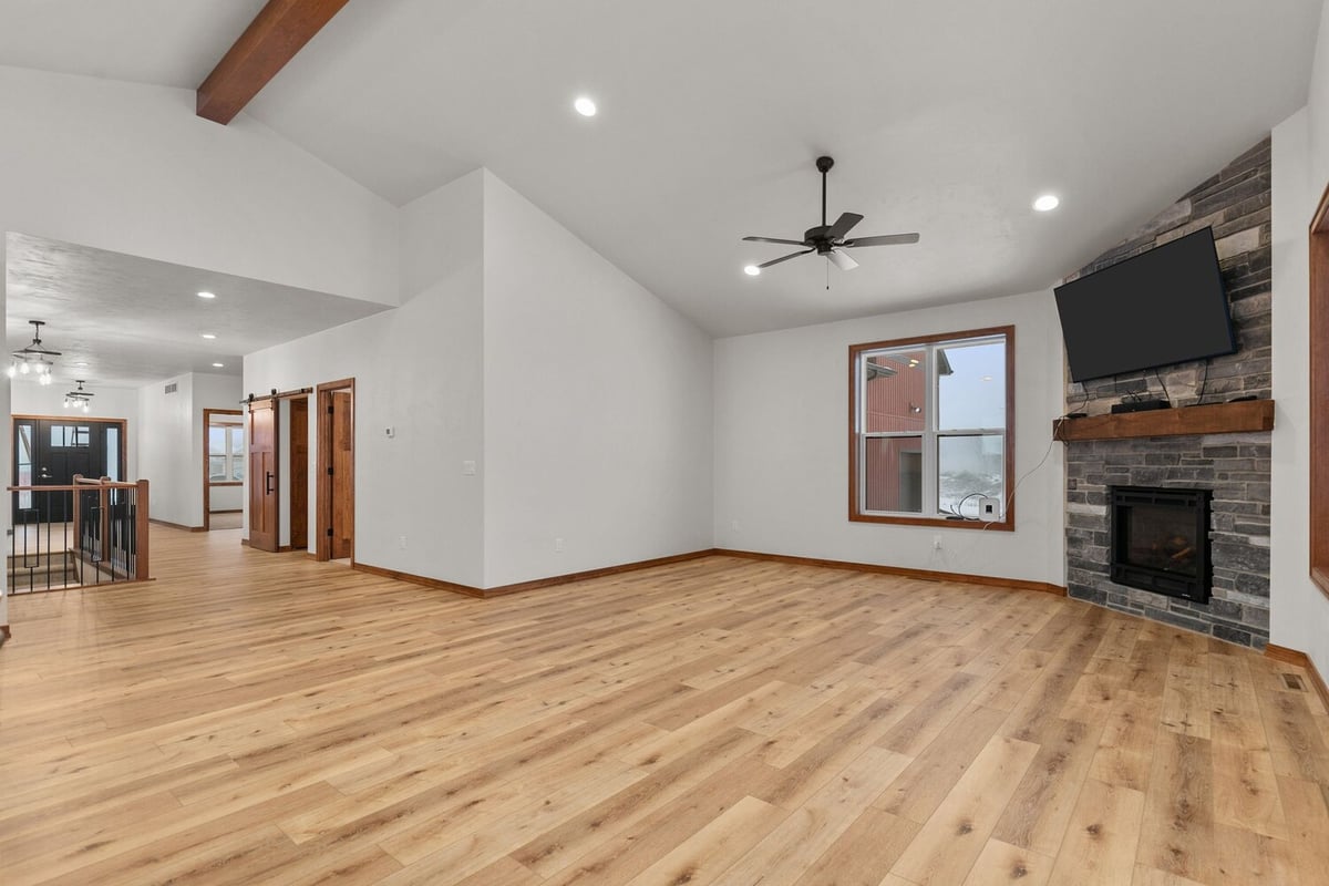 Open living room with fireplace and TV mount by Midwest Design Homes, Kaukauna, WI