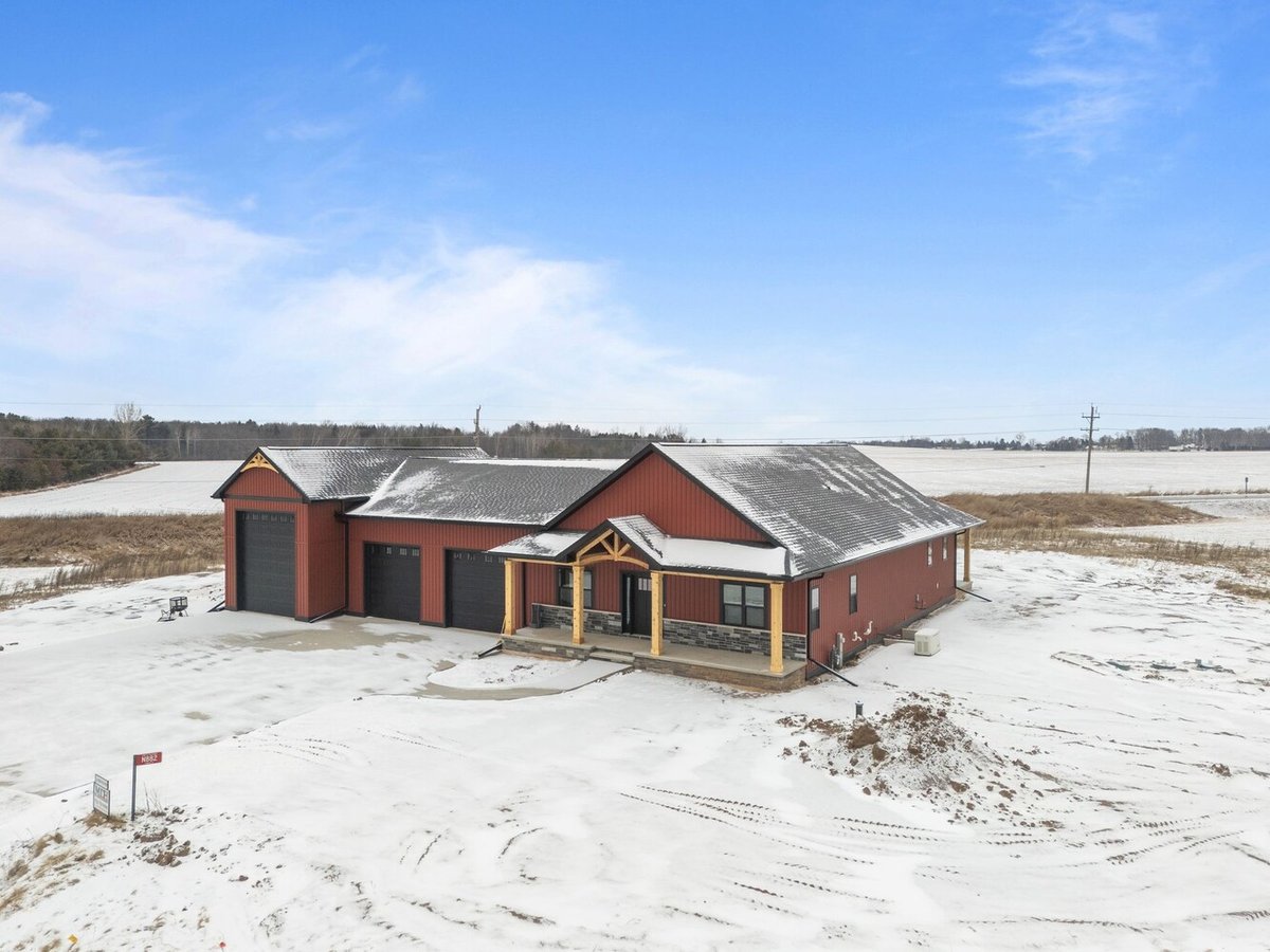 Snowy front view of Wisconsin custom home by Midwest Design Homes in Kaukauna