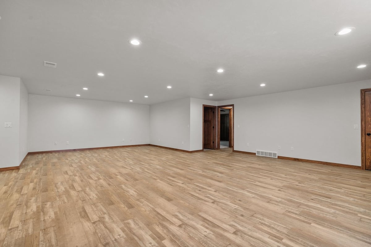 Spacious finished basement with wood flooring by Midwest Design Homes in Kaukauna