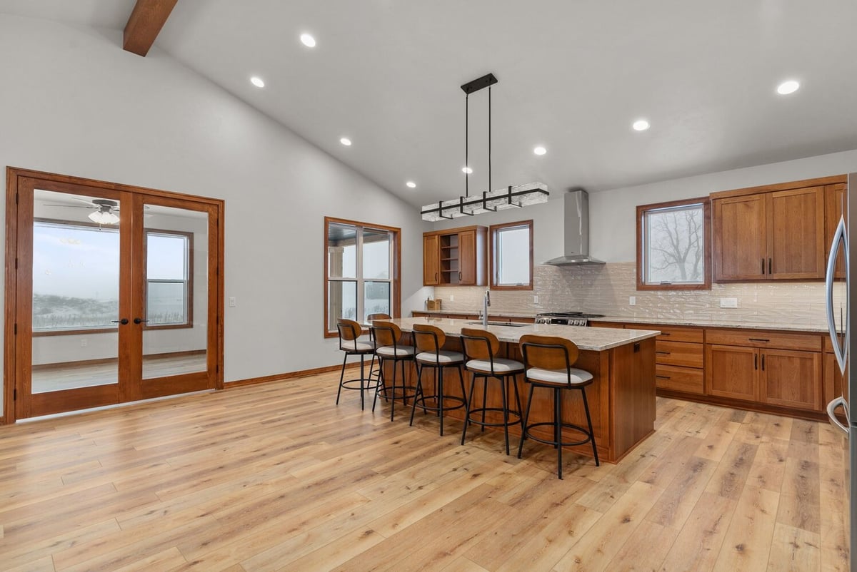 Spacious kitchen with island and seating in custom Kaukauna home by Midwest Design Homes