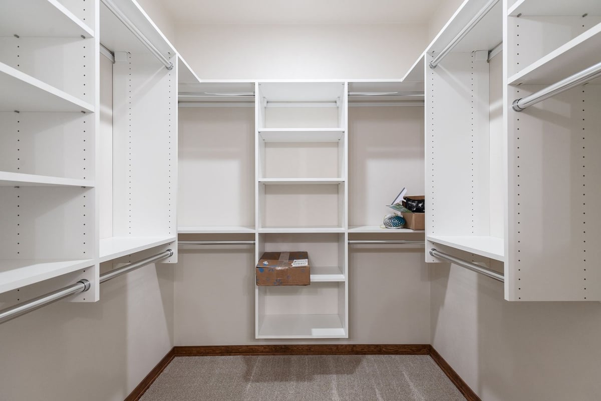 Spacious walk-in closet with shelves in Kaukauna home by Midwest Design Homes