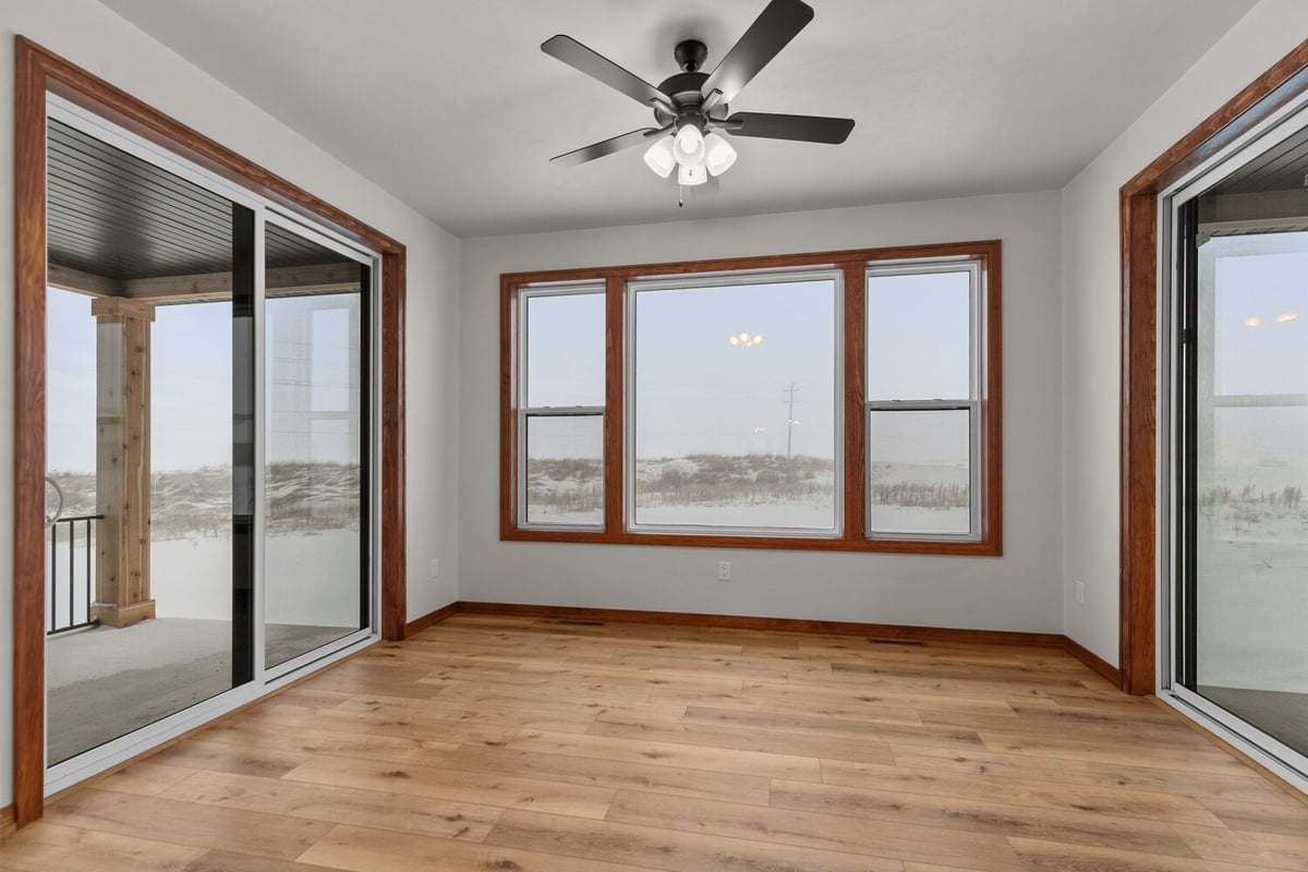 Sunroom with natural light and outdoor views in Kaukauna home by Midwest Design Homes