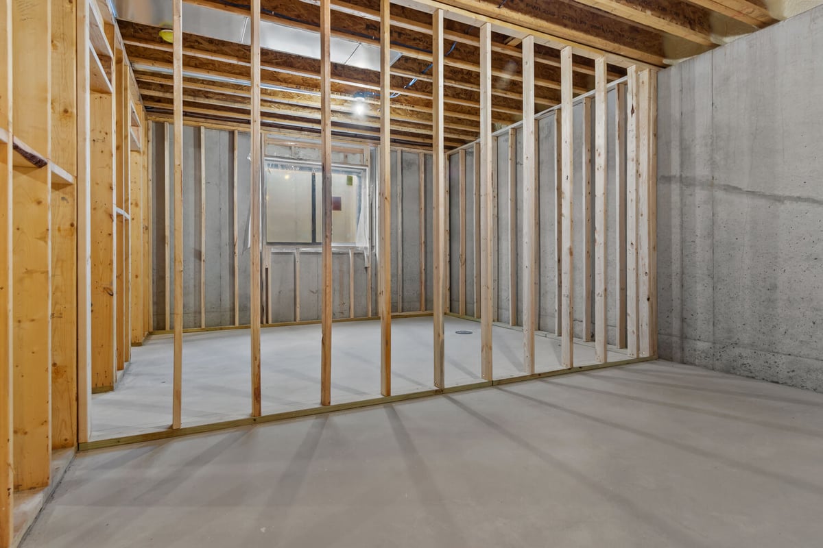 Concrete basement with framed walls by Midwest Design Homes in Lawrence, Wisconsin