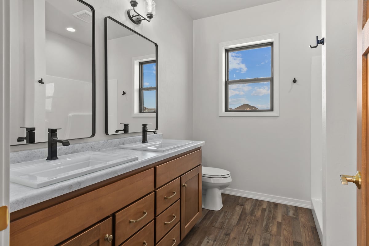Custom bathroom with dual sinks and mirrors by Midwest Design Homes in Neenah, WI