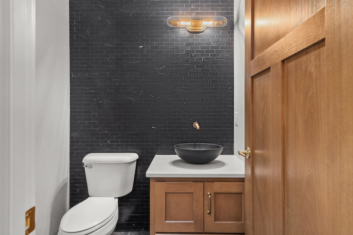 Custom black tile powder room remodel by Midwest Design Homes in Kaukauna, Wisconsin