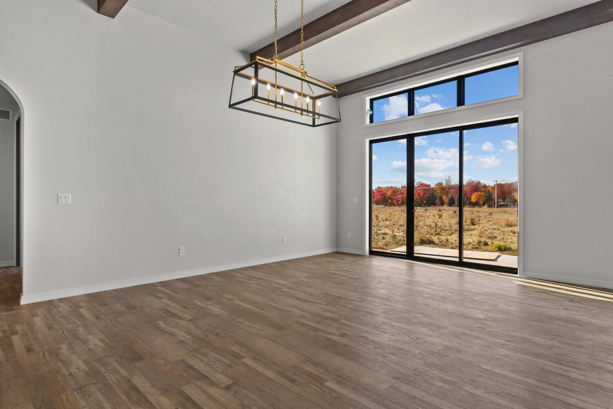 Dining area with modern light fixture by Midwest Design Homes in Kaukauna, Wisconsin