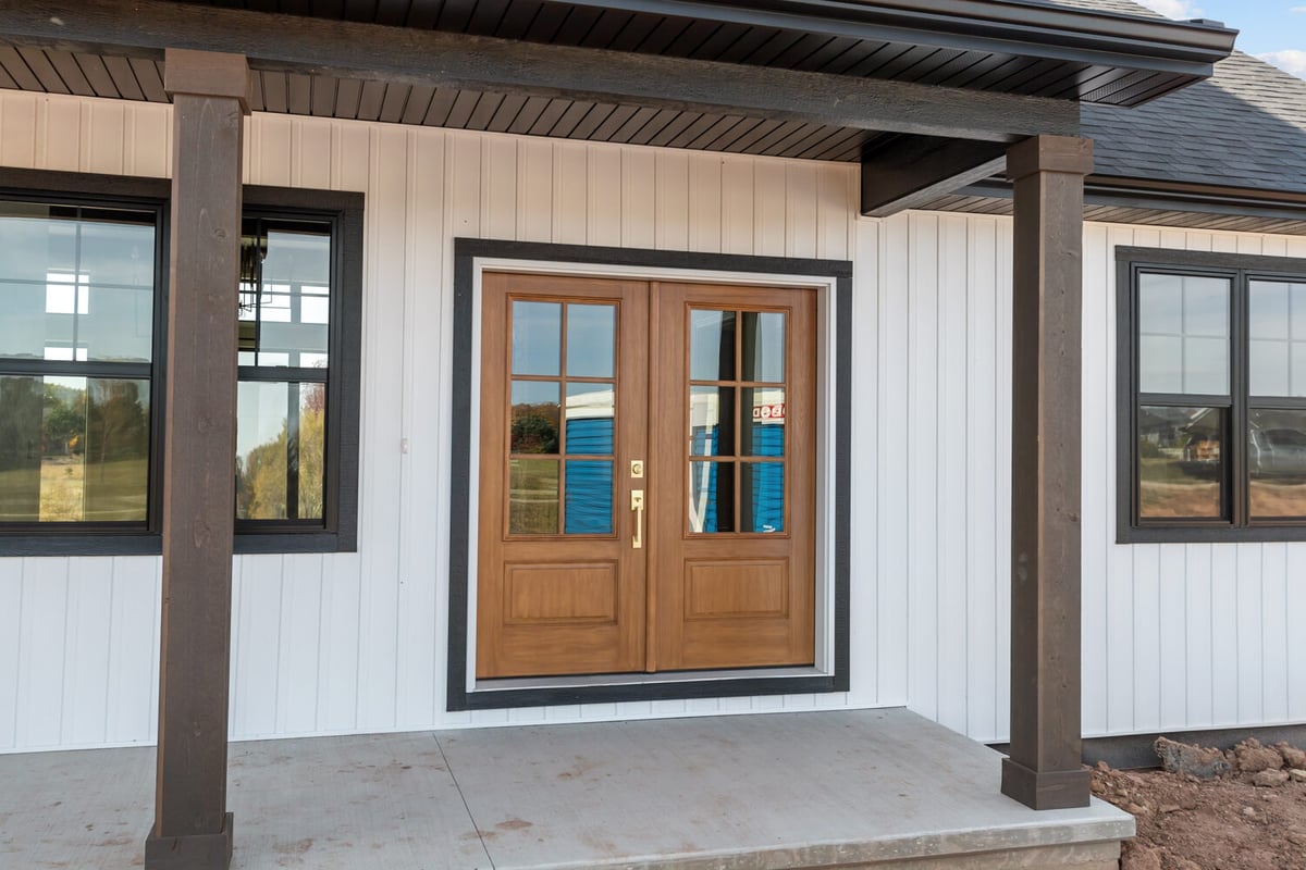 Front entry with double wood doors in Kaukauna, WI custom home by Midwest Design Homes
