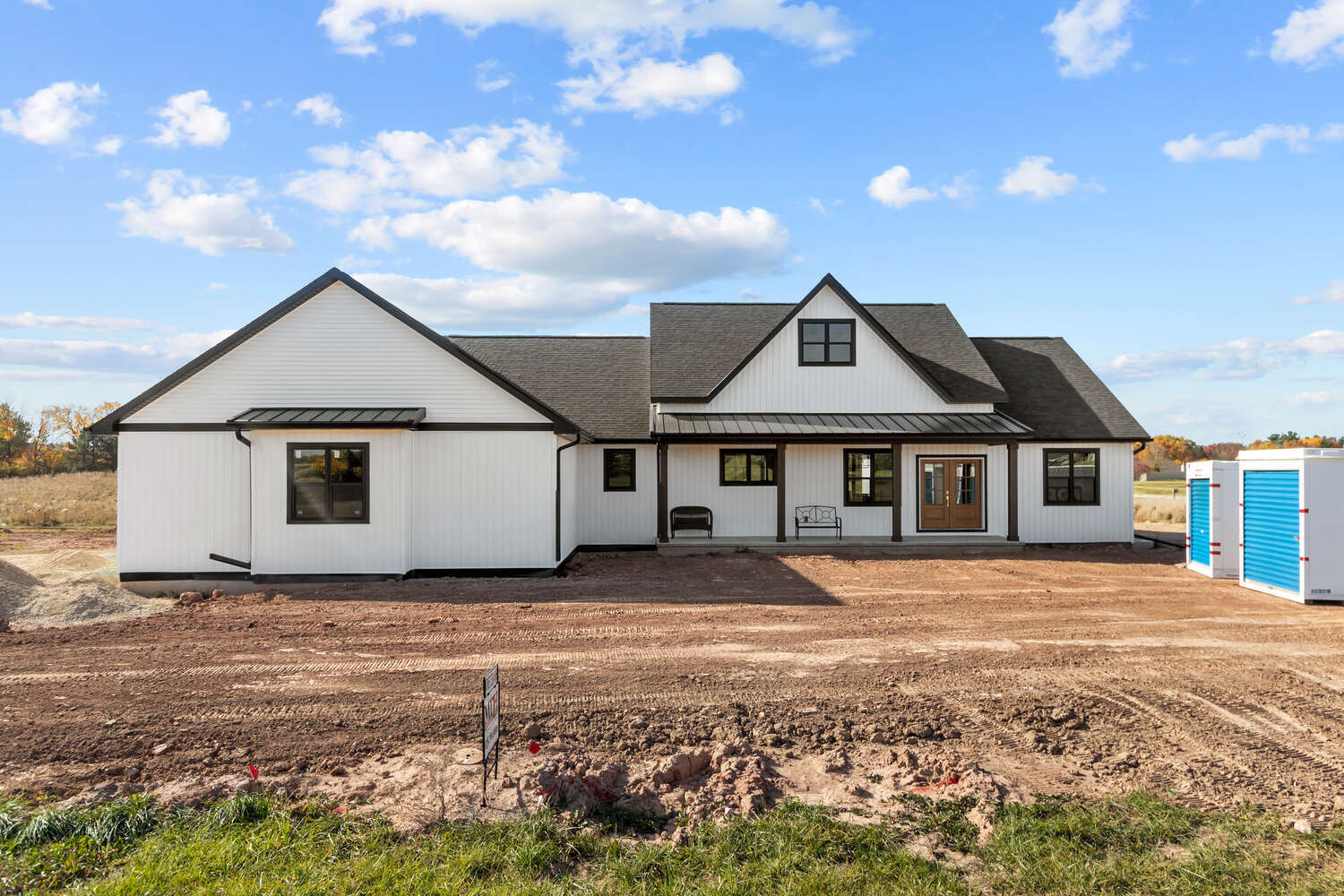 Front exterior of custom white home in Kaukauna, WI by Midwest Design Homes