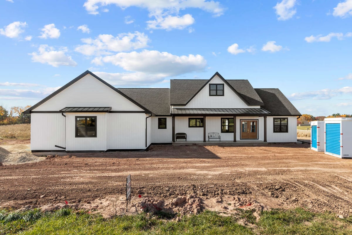 Front exterior of custom white home in Kaukauna, WI by Midwest Design Homes