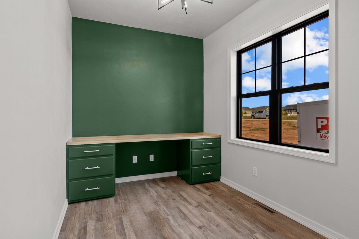 Green accent wall office space by Midwest Design Homes in Greenville, Wisconsin