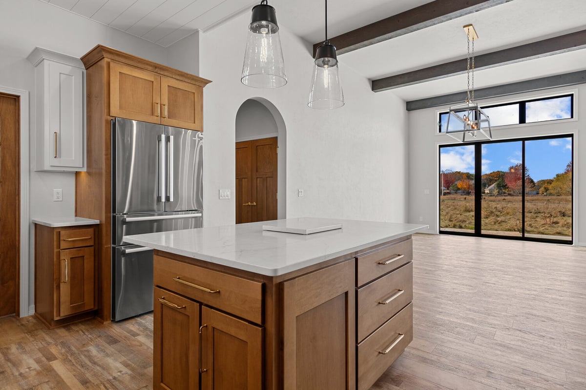 Kitchen island and open dining space in custom home by Midwest Design Homes in Lawrence WI