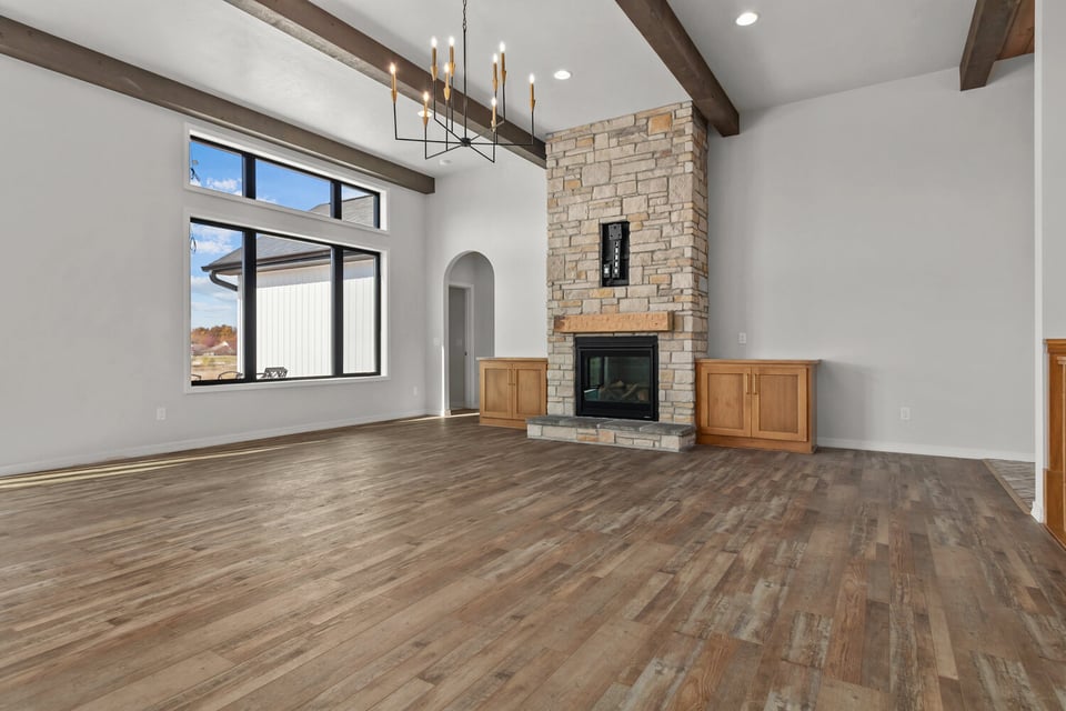 Large stone fireplace with custom cabinetry by Midwest Design Homes in Ledgeview, WI