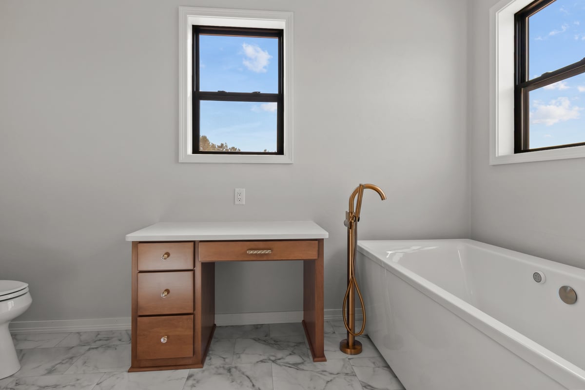 Modern tub and vanity bathroom setup by Midwest Design Homes in Ellington, Wisconsin