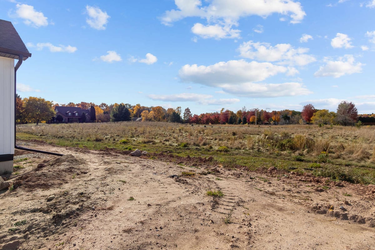 Open lot beside custom home in Kaukauna, WI by Midwest Design Homes