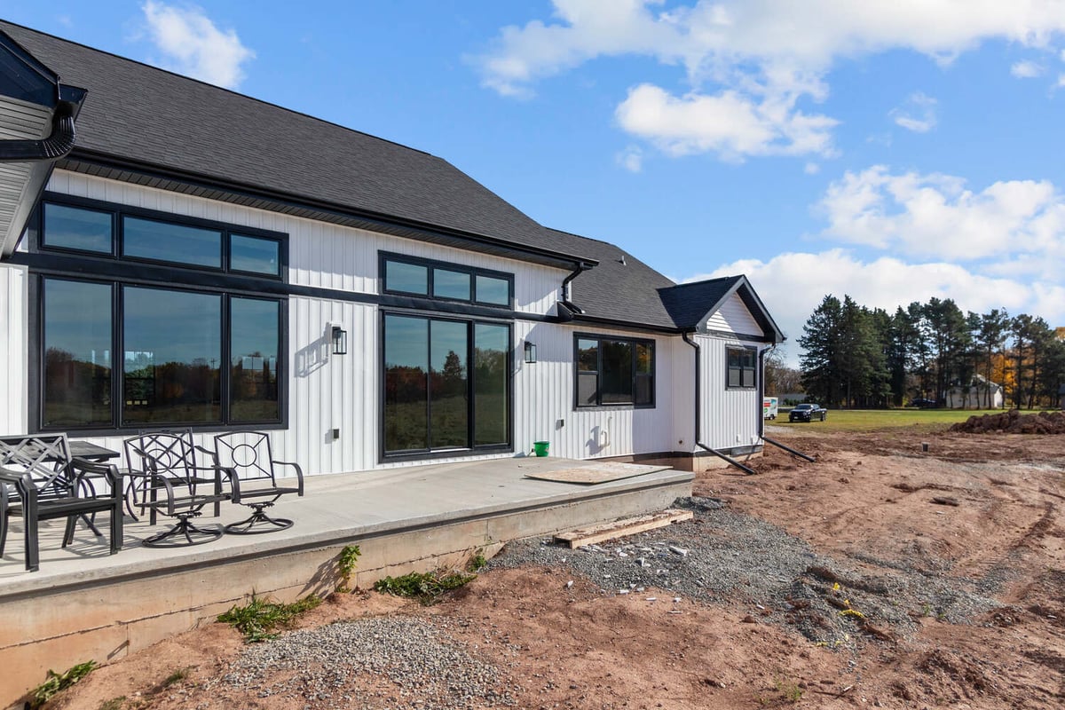 Rear exterior of custom home with large windows in Kaukauna by Midwest Design Homes