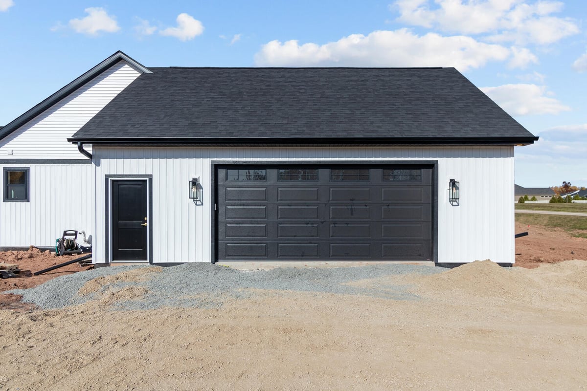 Side entry and garage exterior of custom Kaukauna home by Midwest Design Homes