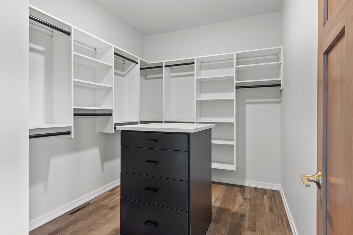 Spacious walk-in closet with island by Midwest Design Homes in Kaukauna, Wisconsin