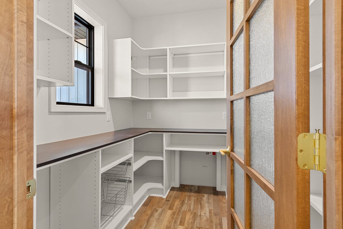 White shelving pantry in custom home by Midwest Design Homes in Green Bay Wisconsin