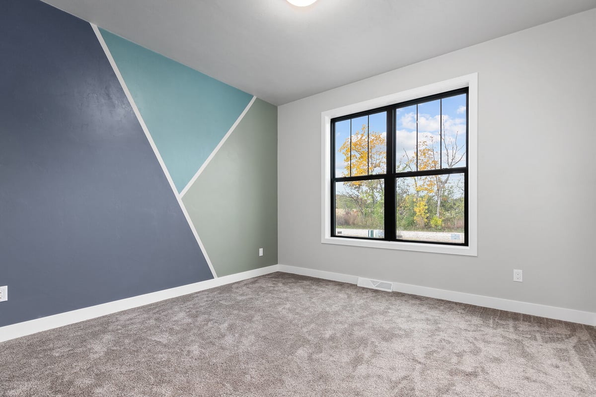 Accent wall bedroom with geometric design in custom home by Midwest Design Homes, Kaukauna WI