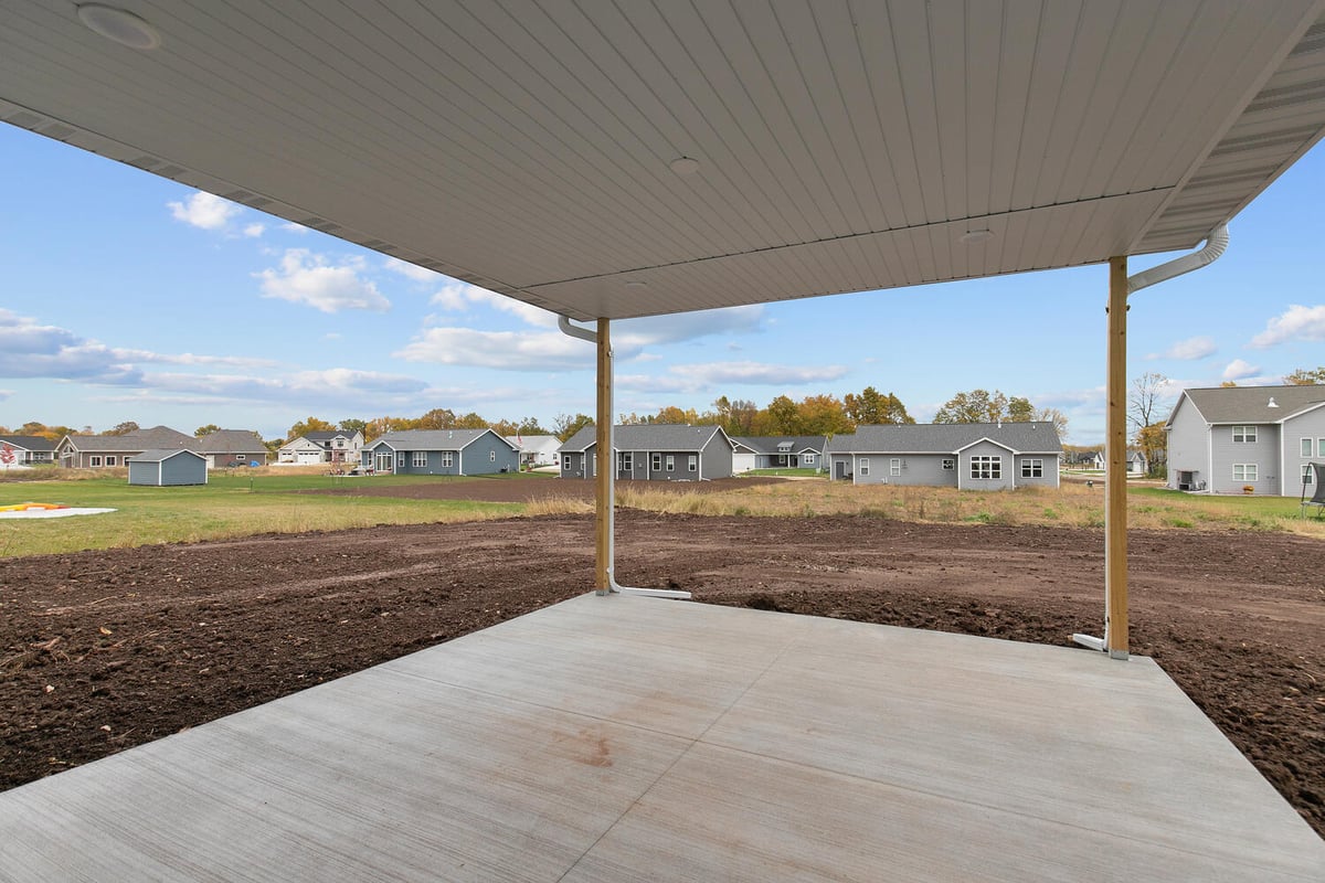 Backyard view from covered patio in Midwest Design Homes Kaukauna custom home